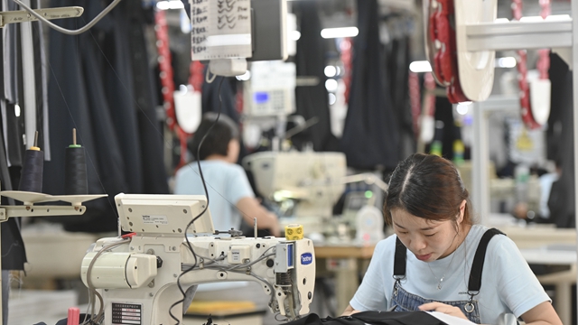 工人在福建一家纺织服装企业的生产车间工作。新华社资料